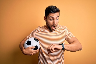 Football Fan Looks at Watch